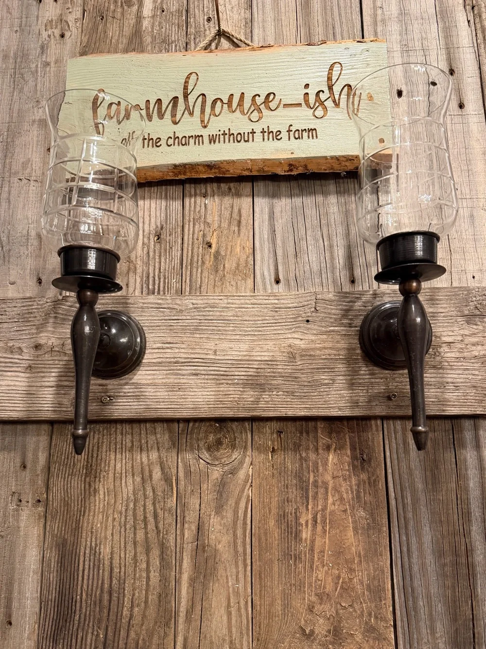 Pair of farmhouse dark bronze-toned metal candle sconces with clear glass